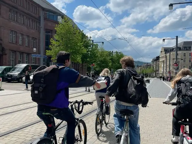 A student cycling through a German town